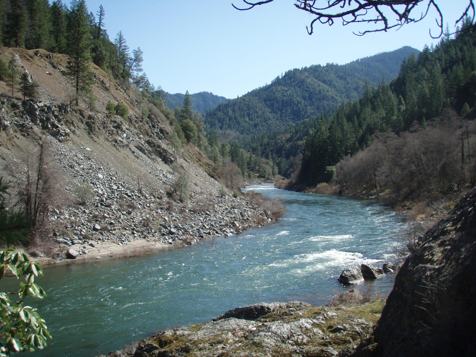 The Klamath River winding between forested mountains